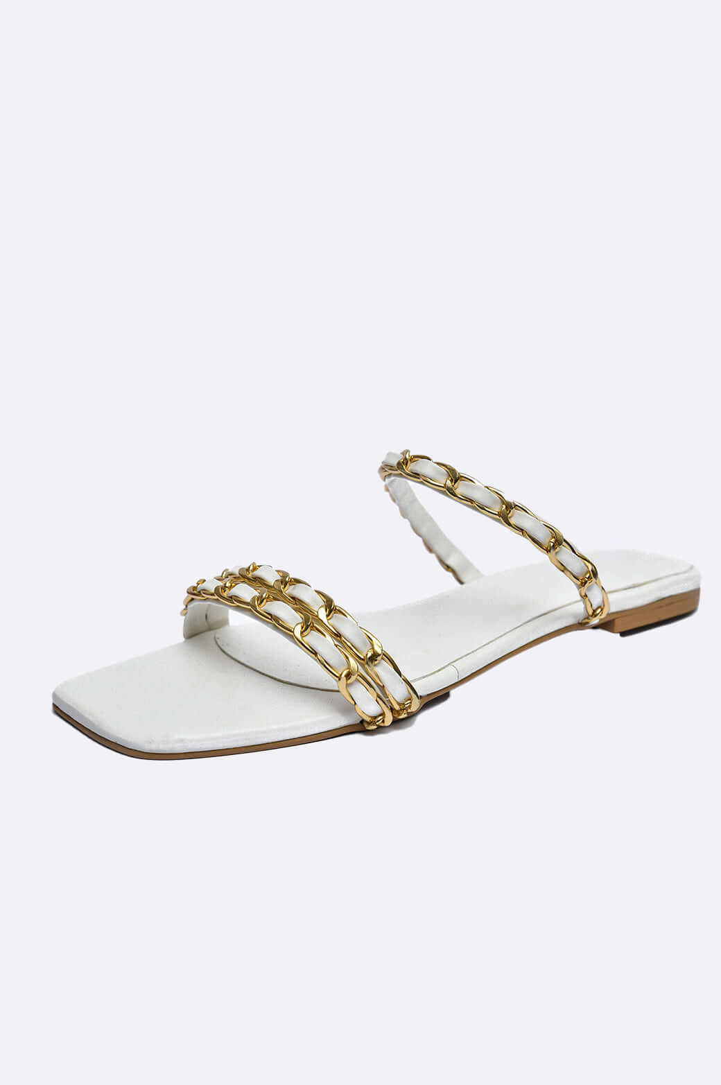 Handmade white leather slippers with gold-plated chain links, redefining luxury in ladies footwear from UAE.