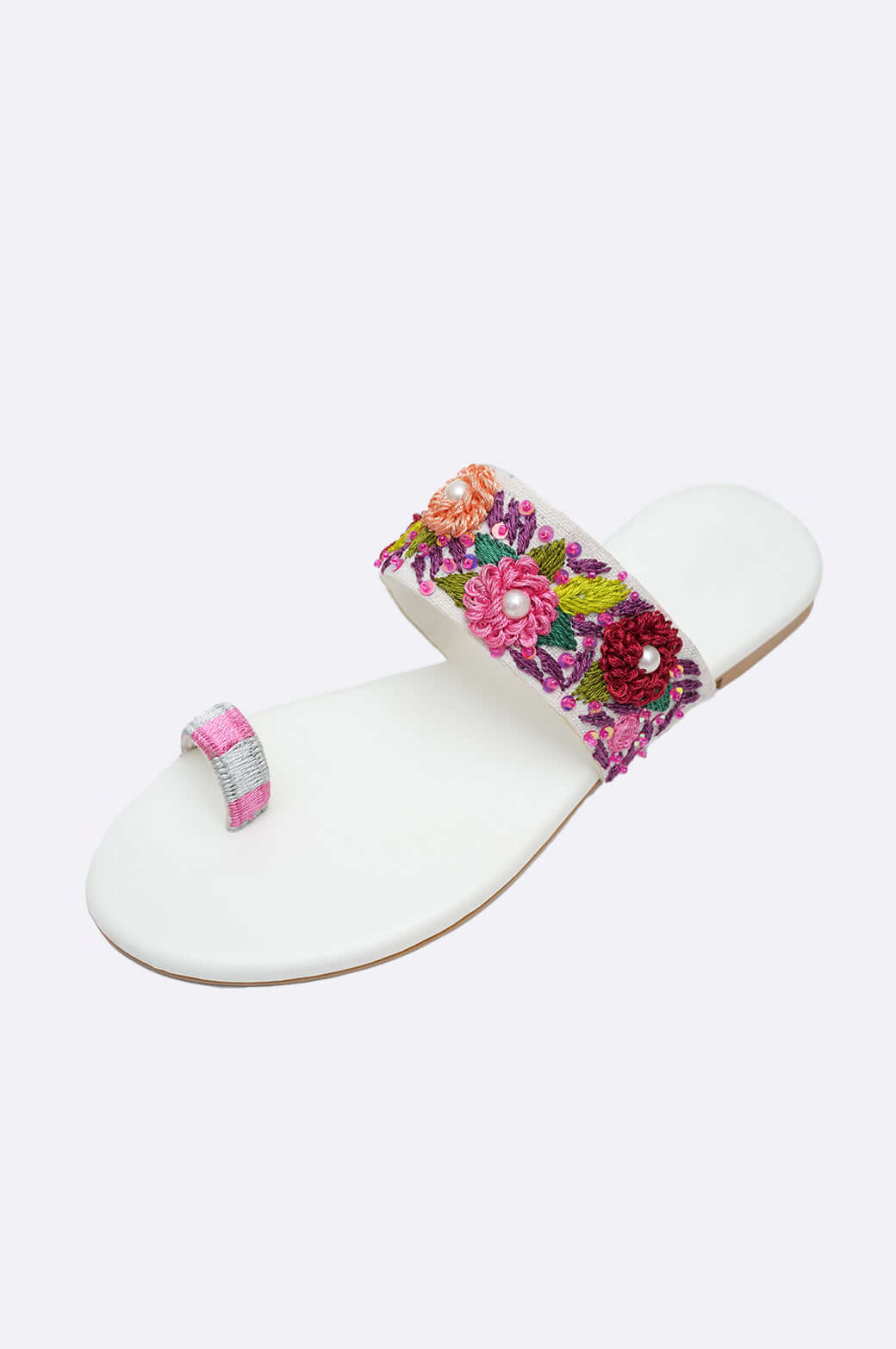 Handmade white leather sandals with vibrant floral embroidery and pearl embellishments, perfect ladies footwear from UAE.