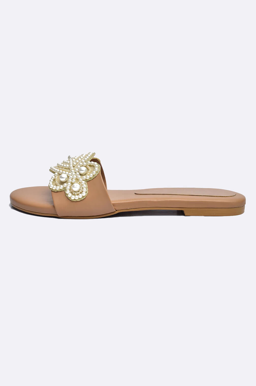 Handmade tan leather flats with pearl floral appliqué, elegant ladies footwear from UAE, perfect for stylish occasions.