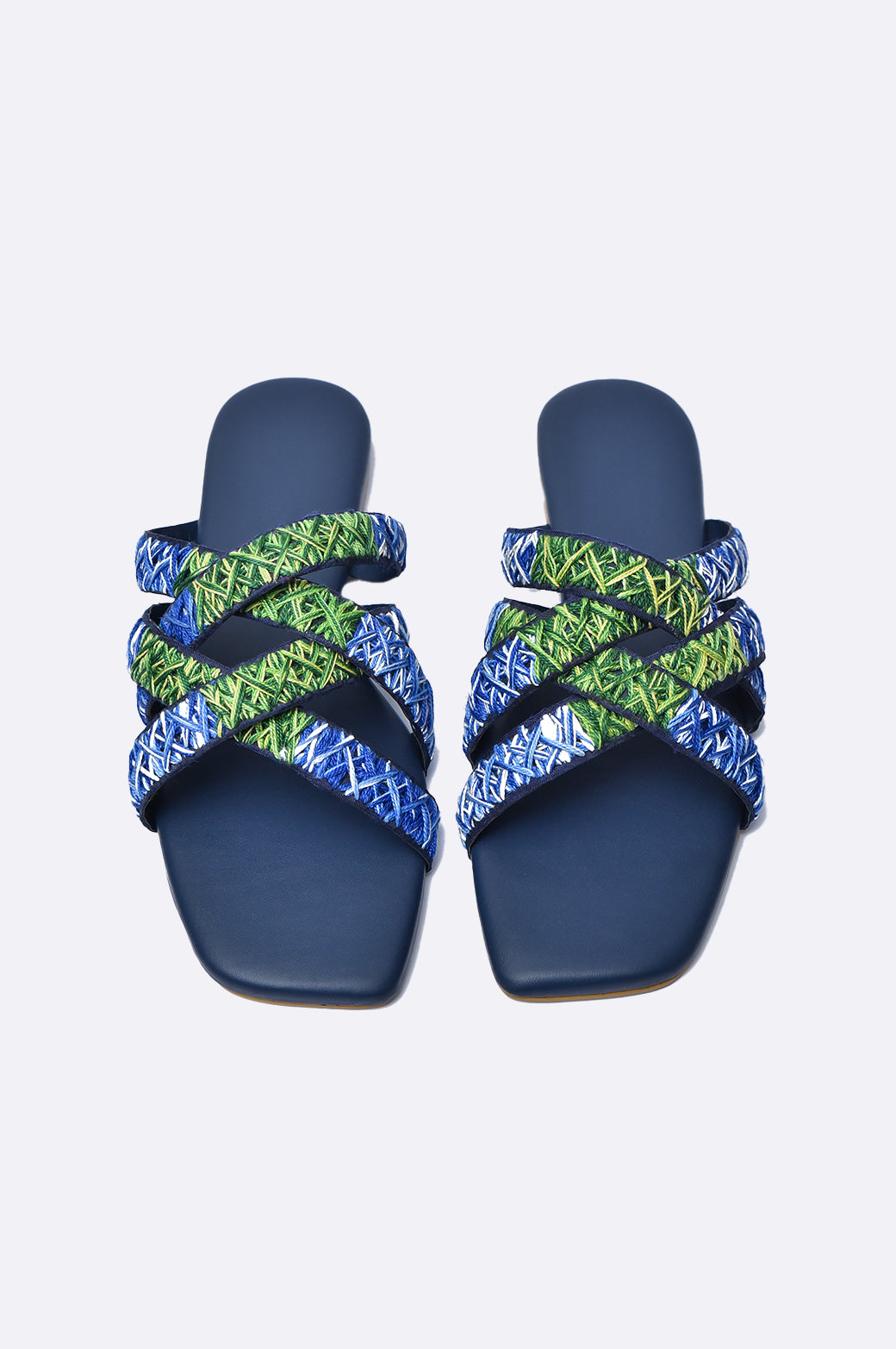 Cool Cami handmade leather flat slipper with blue and green embroidered cross-straps on navy sole, luxury women’s footwear from UAE.