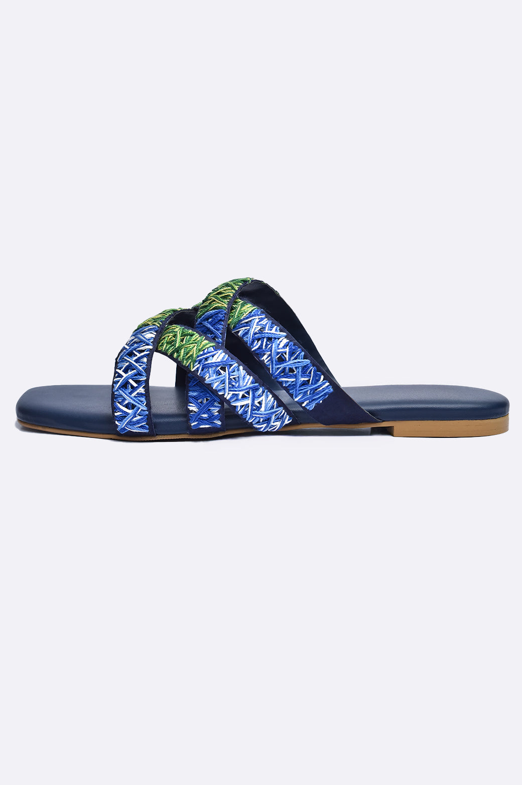 Cool Cami handmade leather flat slipper with blue and green embroidered cross-straps on navy sole, luxury women’s footwear from UAE.