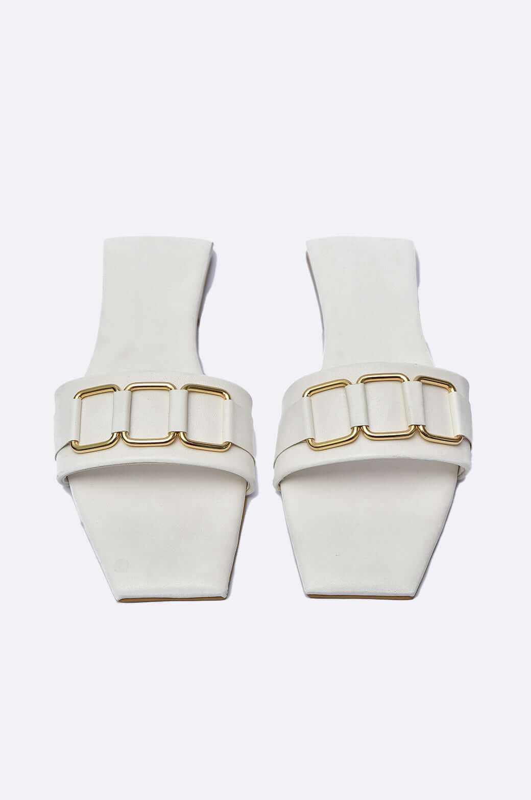 Handmade white leather flat slide shoes with gold buckles by Cool Cami, perfect for ladies footwear in UAE.